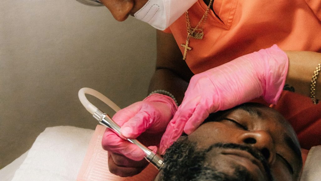 a man getting his teeth checked by a dentist